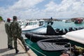 Two Maldivian military man standing near army boats