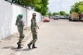 Two maldivian military women crossing street