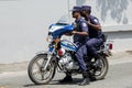 Two maldivian policemen riding on motorbike at street