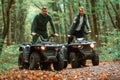 Two male atv riders is in the forest together Royalty Free Stock Photo