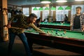 Two male billiard players spend time in poolroom Royalty Free Stock Photo