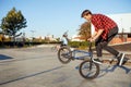 Two male bmx bikers doing tricks in skatepark Royalty Free Stock Photo