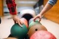 Two male bowlers takes balls from feeder Royalty Free Stock Photo