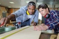 two male carpenters working together in workshop