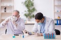 Two male chemists working at the lab during pandemic Royalty Free Stock Photo