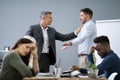 Two Male Colleagues Fighting In Office Royalty Free Stock Photo