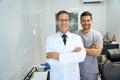 Two male dentists smiling and looking professional