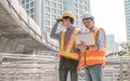Two male engineers working outside and discuss about construction project Royalty Free Stock Photo