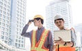 Two male engineers working outside and discuss about construction project Royalty Free Stock Photo