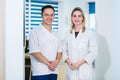 Two Male and Female Doctors or Nurses Standing Inside Hospital Building. Royalty Free Stock Photo