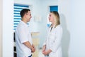 Two Male and Female Doctors or Nurses Standing Inside Hospital Building. Royalty Free Stock Photo