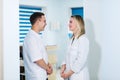 Two Male and Female Doctors or Nurses Standing Inside Hospital Building. Royalty Free Stock Photo