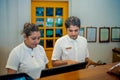 Two male and female receptionists on duty at the tropical resort