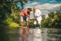 Two male friends fishing together. Fisherman with rod. Relax on nature. Cheers. It is not sport it is obsession. Fishing