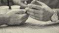 Two male friends looking at the screen of a mobile phone, detail on hands Royalty Free Stock Photo