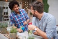 Two male friends socializing in cafe outside