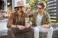 Two male friends talking on a porch of the country house Royalty Free Stock Photo