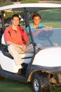 Two Male Golfers Riding In Golf Buggy Royalty Free Stock Photo