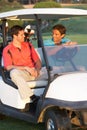 Two Male Golfers Riding In Golf Buggy Royalty Free Stock Photo