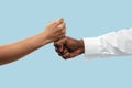 Two male hands competion in arm wrestling isolated on blue studio background