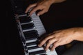 Two male hands on the piano. palms lie on the keys and play the keyboard instrument in the music school. student learns to play. Royalty Free Stock Photo