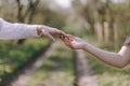 Two male hands reaching towards each other, almost touching with fingers, lighting spark in galaxy background concept Royalty Free Stock Photo