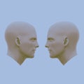 Two male heads facing each other