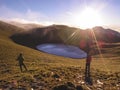 Two male hikers standing on a higher place by the Jiaming lake, and enjoying the beautiful sunrise. Royalty Free Stock Photo