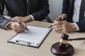 Two male lawyers are consulting together to draft a contract acknowledgment for their clients. Royalty Free Stock Photo