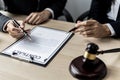 Two male lawyers are consulting together to draft a contract acknowledgment for their clients. Royalty Free Stock Photo