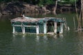 Two male mallard ducks rest on a wooden houseboat on a lake in a park in the summer after noon