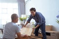 Two Male Movers Carrying a furniture and assmble it Royalty Free Stock Photo