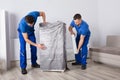 Two Male Movers Packing Furniture Royalty Free Stock Photo