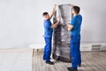 Two Male Movers Packing Furniture Royalty Free Stock Photo