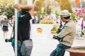 Two male photographers are waiting for customers to hire to take pictures at Dalat Flower Gardens