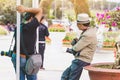 Two male photographers are waiting for customers to hire to take pictures at Dalat Flower Gardens