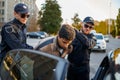 Two male police officers arrest young man Royalty Free Stock Photo