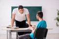 Two male pupils in bullying concept in the classroom