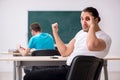 Two male pupils in bullying concept in the classroom