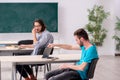 Two male pupils in bullying concept in the classroom