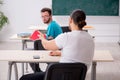 Two male pupils in bullying concept in the classroom