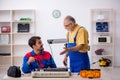 Two male repairmen repairing air-conditioner Royalty Free Stock Photo