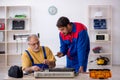 Two male repairmen repairing air-conditioner Royalty Free Stock Photo