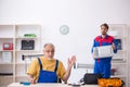 Two male repairmen working at workshop Royalty Free Stock Photo