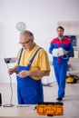 Two male repairmen working at workshop Royalty Free Stock Photo