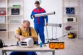 Two male repairmen working at workshop Royalty Free Stock Photo