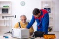 Two male repairmen working at workshop Royalty Free Stock Photo