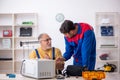 Two male repairmen working at workshop Royalty Free Stock Photo
