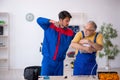 Two male repairmen working at workshop Royalty Free Stock Photo