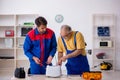 Two male repairmen working at workshop